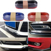 Close-up view of a black carbon fiber rubber anti-collision strip protector for a car front bumper lip.