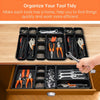 A wooden drawer organizer tray with multiple black compartments holding various tools and hardware.