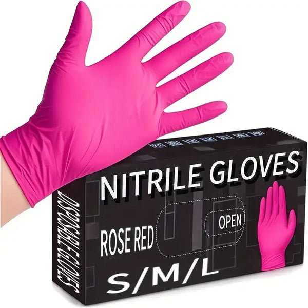 A hand wearing a bright pink nitrile disposable glove is shown next to its packaging box.