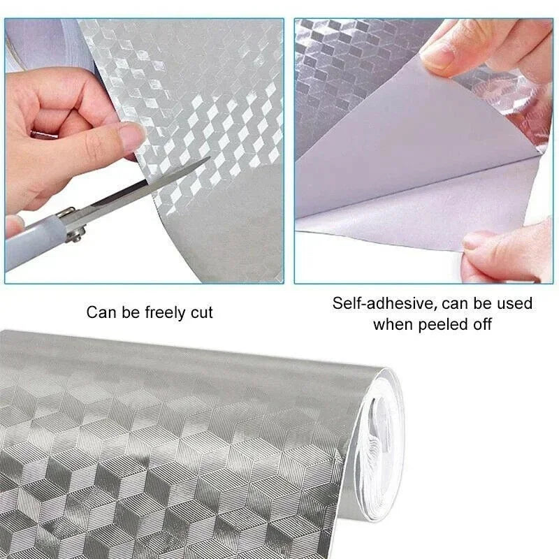 Roll of silver self-adhesive aluminum foil wallpaper being cut and peeled off to show its texture