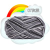 A ball of gray and white milk cotton blend yarn with a rainbow graphic above it.