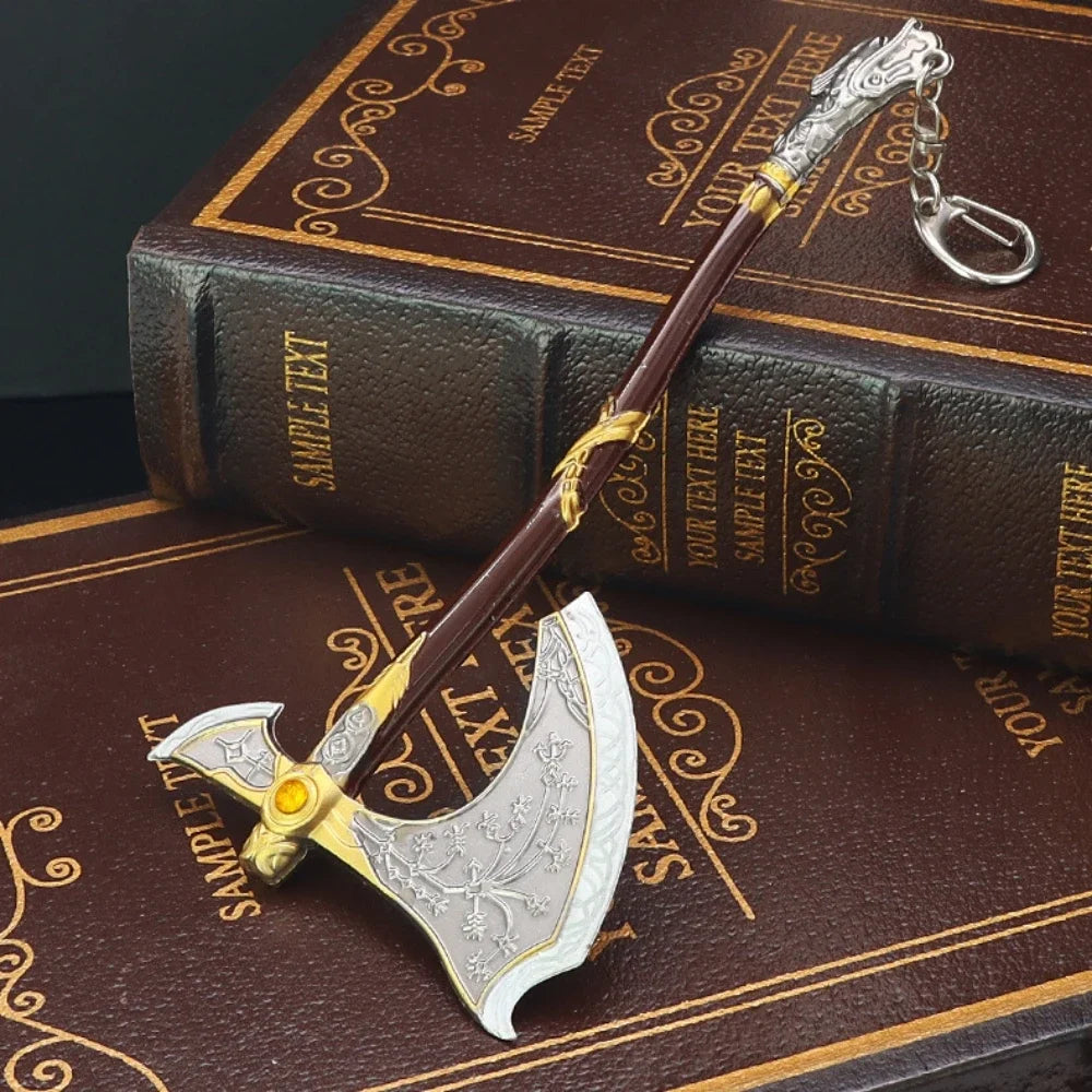 A detailed metal sword keychain with a decorative hilt and blade is displayed on a brown leather-bound box.