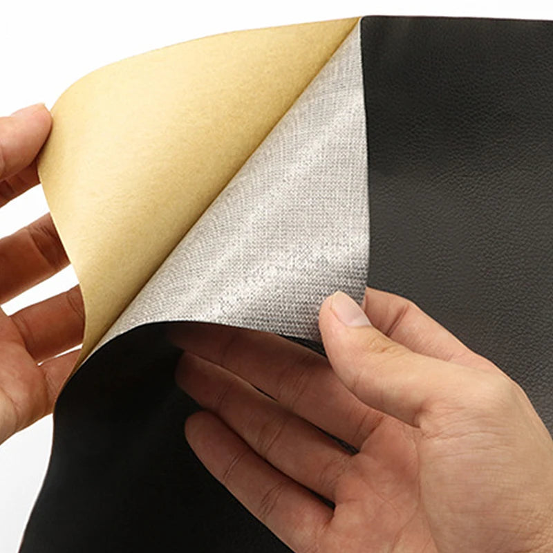 A hand is peeling a gray self-adhesive PU leather repair patch from a yellow backing sheet.