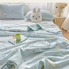 Light blue quilt with a pastoral print featuring clouds, stars, and a cream-colored stuffed animal.