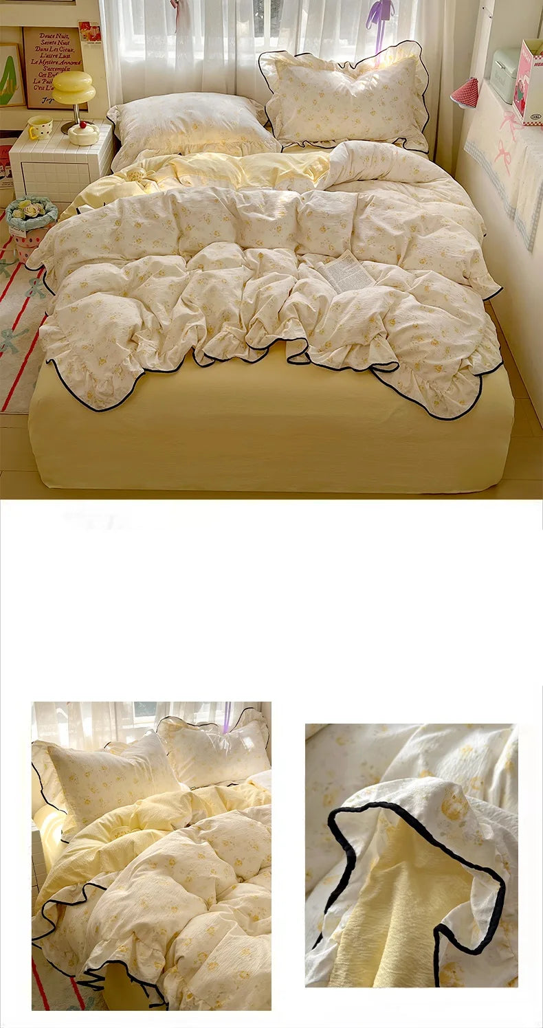 A set of floral duvet cover, pillowcases, and a flat sheet in cream and yellow tones.