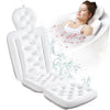 A white full-body bath pillow with head and neck support is shown, used for relaxing baths.