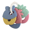 A set of silicone fruit teethers and a rattle for babies in pastel colors like blue, yellow, pink, and green.