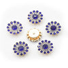 A collection of twelve round, blue and clear rhinestones arranged in a circular pattern on a white background.