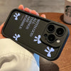 A hand holds a black silicone phone case with white bow graphics and the text All Things Are Possible with God printed on it.