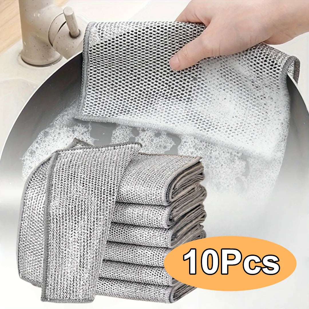 A hand is holding a stack of 10 reusable steel wire scrubber dishcloths, showing the mesh texture and gray color.