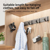 A set of six no-drill aluminum wall hooks with adhesive backing are shown hanging various items like towels, clothes, and key
