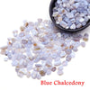 A pile of light blue to lavender blue chalcedony crystal chips in a black bowl.