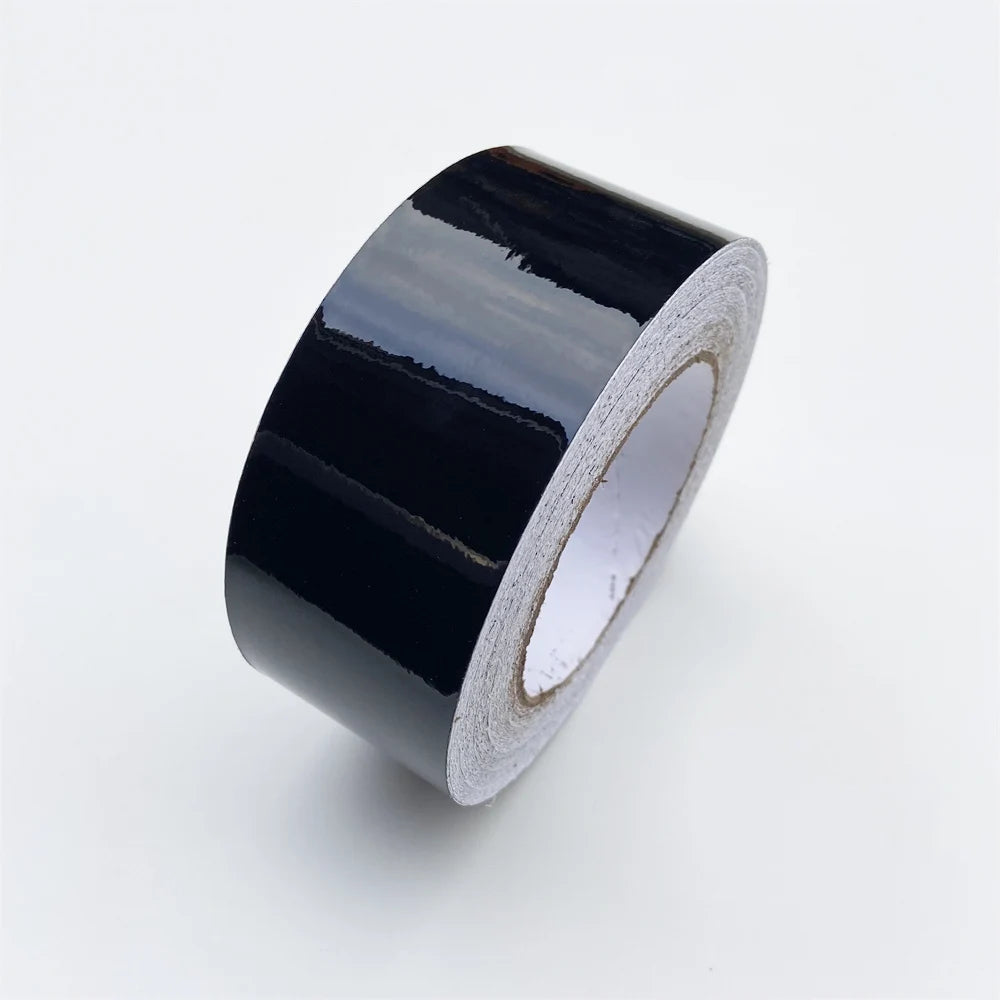 Roll of glossy black vinyl wrap strip for car trim and protection