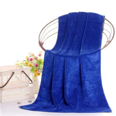 A vibrant royal blue ultra-soft microfiber bath towel draped elegantly.