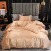 A luxurious beige silky duvet cover set displayed on a bed with gray pillows and dark gold accents.