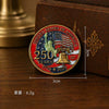 A round enamel pin featuring the United States of America design with an eagle and a bell, set against a brown box.