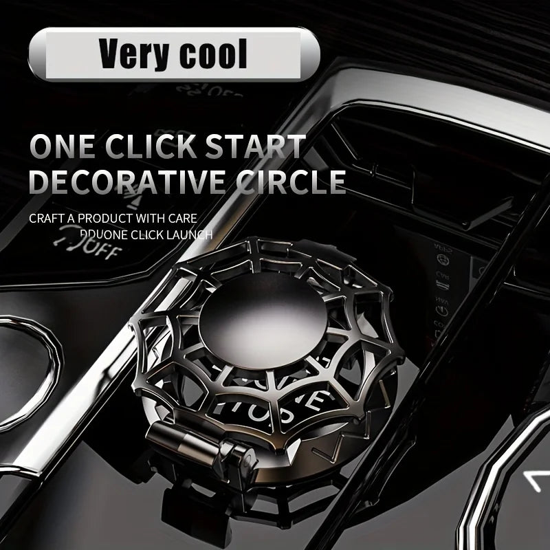 A close-up of a decorative metal circle used as a one-click start cover for a vehicle ignition.