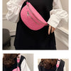 A pink multi-pocket PU leather waist bag with an adjustable strap is shown being held by a woman wearing a black top and whit