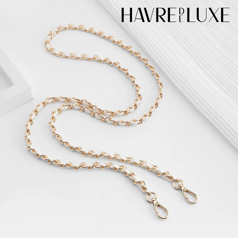 Gold-toned metal chain shoulder strap buckle for a crossbody bag.