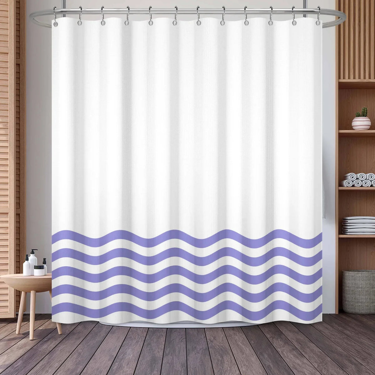 White shower curtain featuring a wavy purple and white stripe pattern hanging from a metal rod.