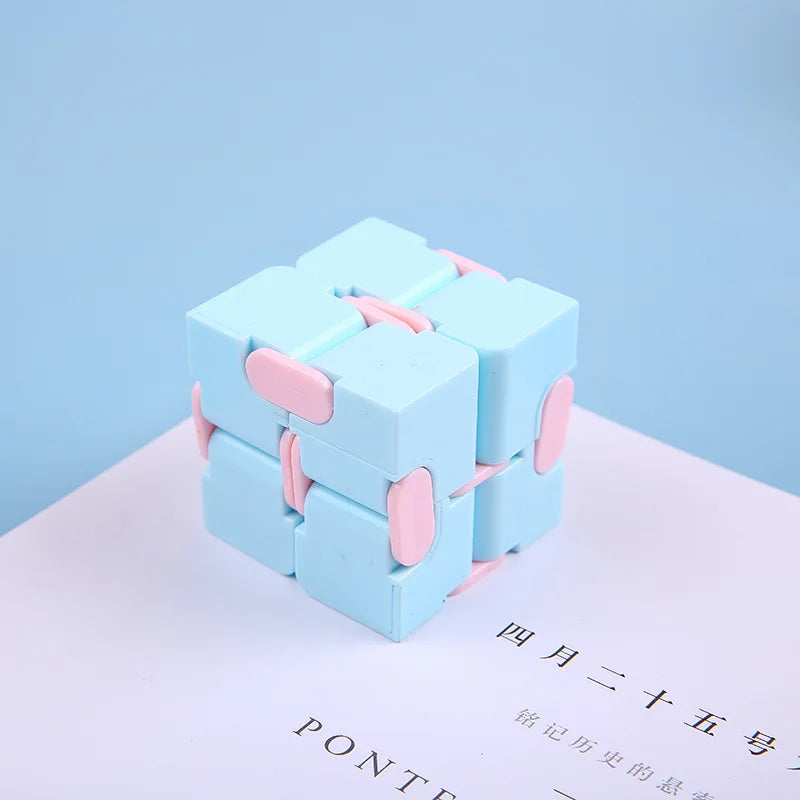 A light blue infinity magic cube fidget toy resting on a white surface.