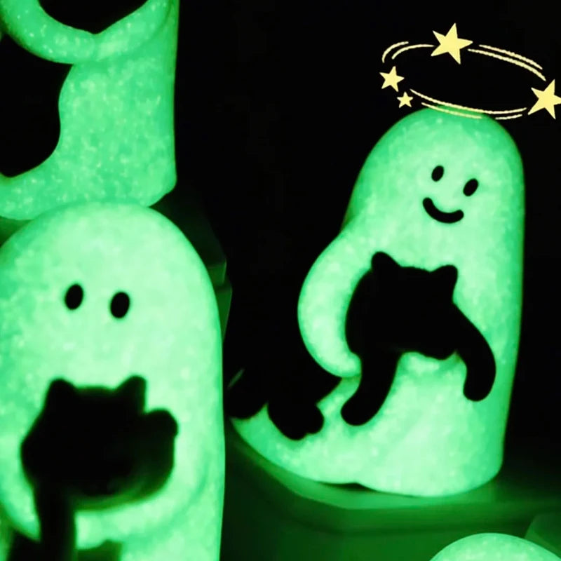 A glowing green ghost figurine with a black cat silhouette is shown in a dark background.