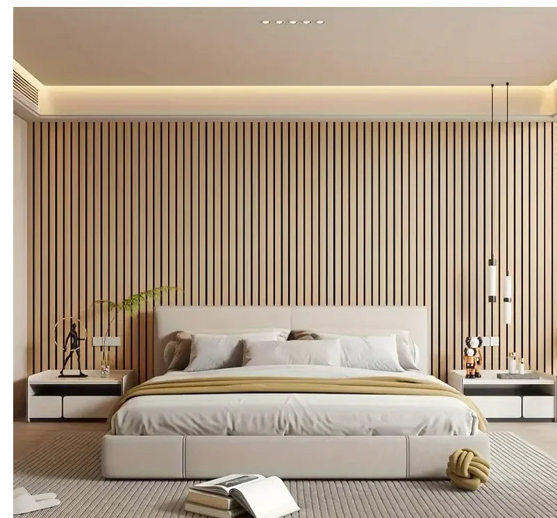 A modern bedroom featuring a bed with white linens against a wall of vertical wood slat panels.