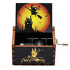 A wooden music box with a Halloween theme featuring a silhouette of a castle against an orange moon and bats.