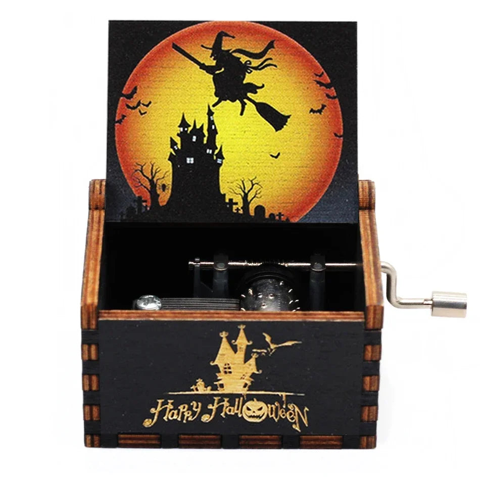 A wooden music box with a Halloween theme featuring a silhouette of a castle against an orange moon and bats.