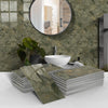 Stacks of green marble self-adhesive wall stickers used as 3D tile decals in a bathroom setting.