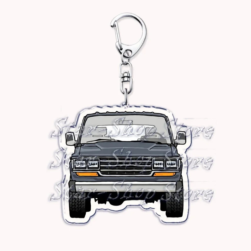 A silver metal key ring attached to a keychain featuring an off-road truck silhouette.