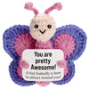 Handmade crochet butterfly doll in purple and pink with a positive message card