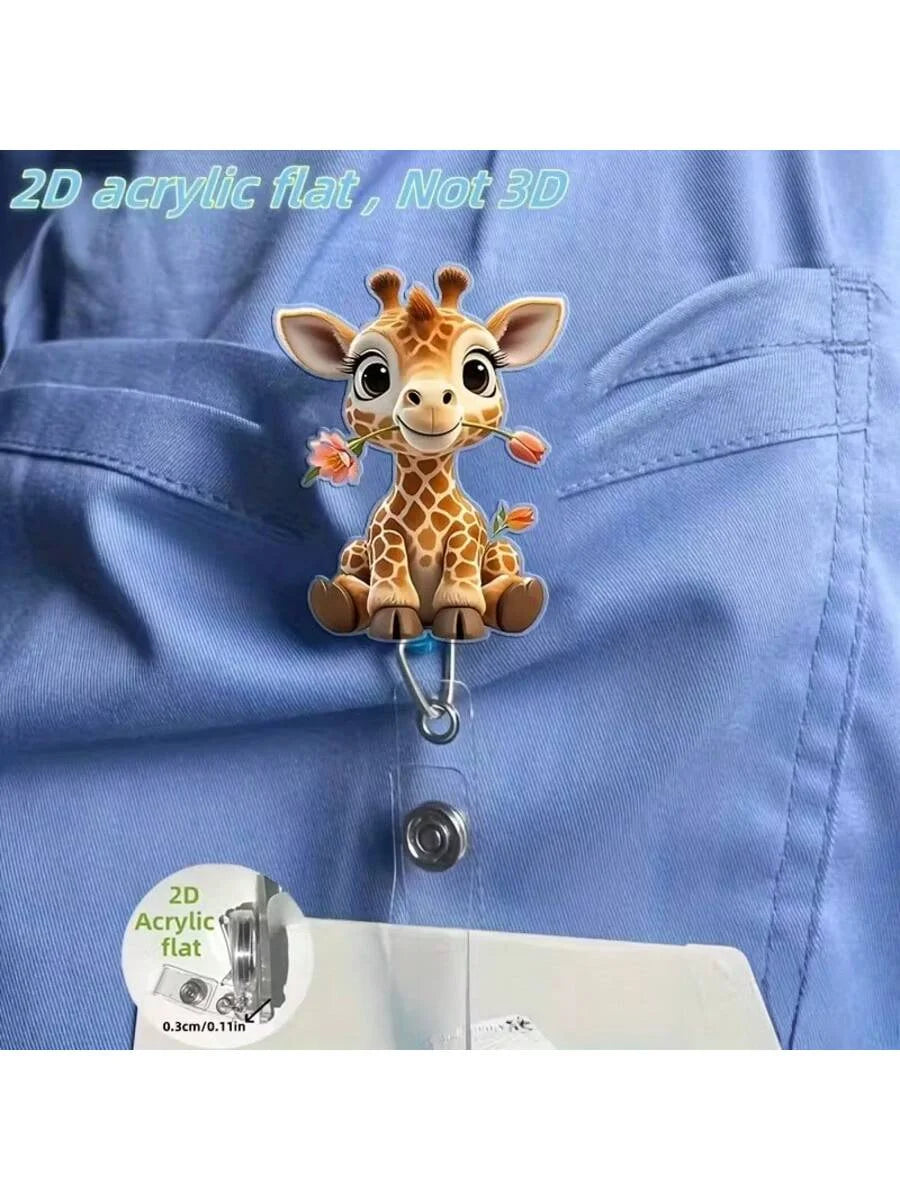 A 2D acrylic flat giraffe charm is clipped onto a blue fabric, demonstrating the product's size.