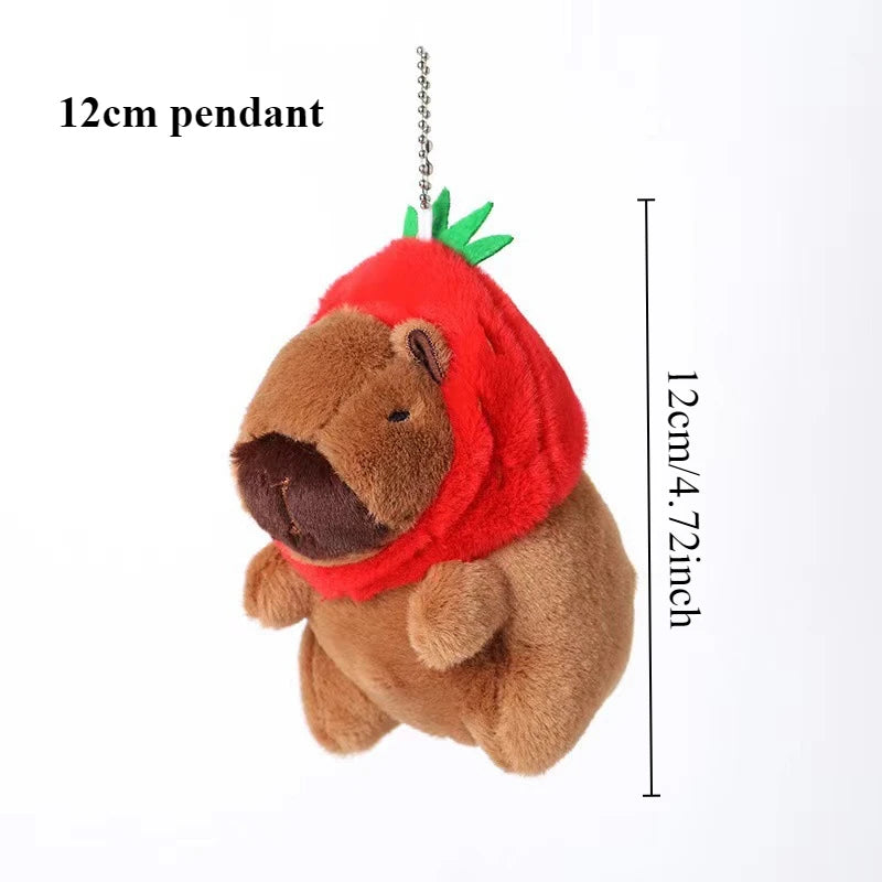 A brown plush toy resembling a capybara with red ears and a green sprout, hanging from a chain.