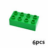 A green building block set containing six circular blocks.