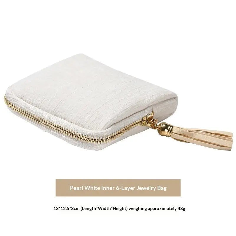 Pearl white inner 6-layer jewelry bag with gold zipper and tassel detail