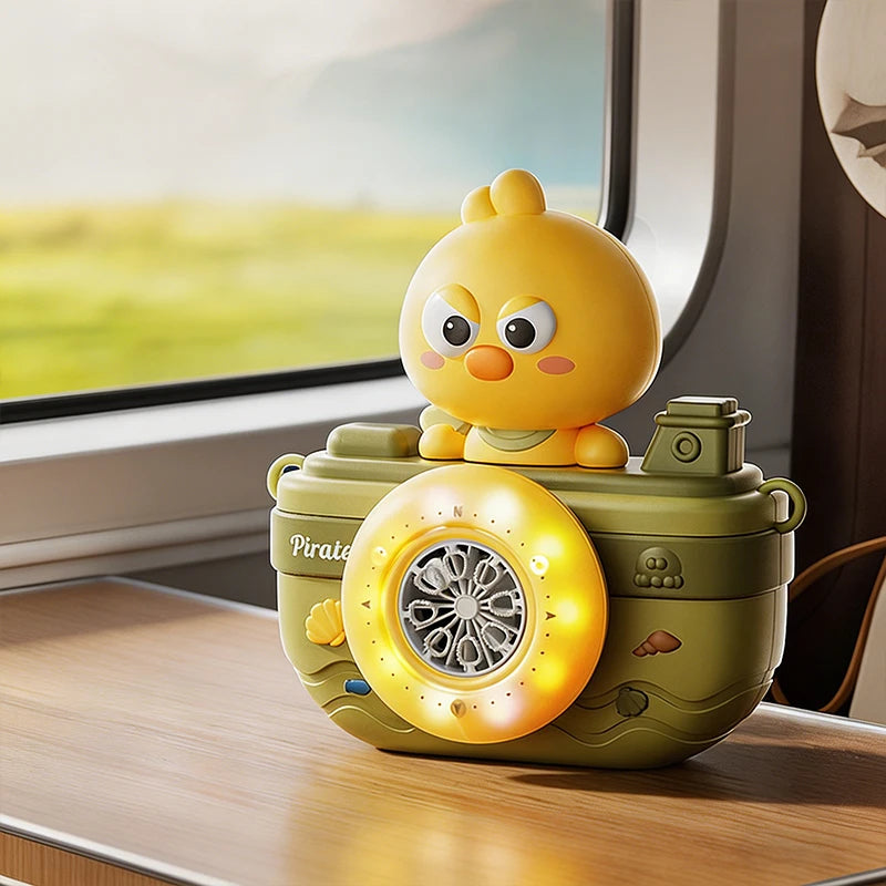 A yellow, camera-shaped automatic bubble machine with lights rests on a wooden surface near a window.