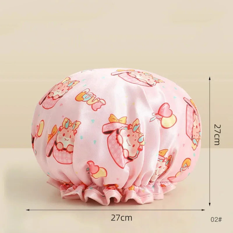 Pink reusable waterproof shower cap with a floral pattern and bow detail