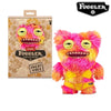 A pink and yellow Fuggler Ugly Monster plush toy with funny teeth and large eyes.