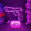 A neon pink gun-shaped night light illuminates a dark surface next to a purple book and flowers.