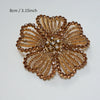 A close-up of a round, textured gold crystal rhinestone flower sew-on patch for clothing and accessories.