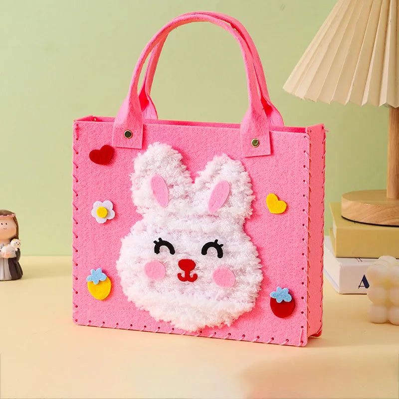 Pink felt bag with a white rabbit face design and pink handles for a sewing craft kit