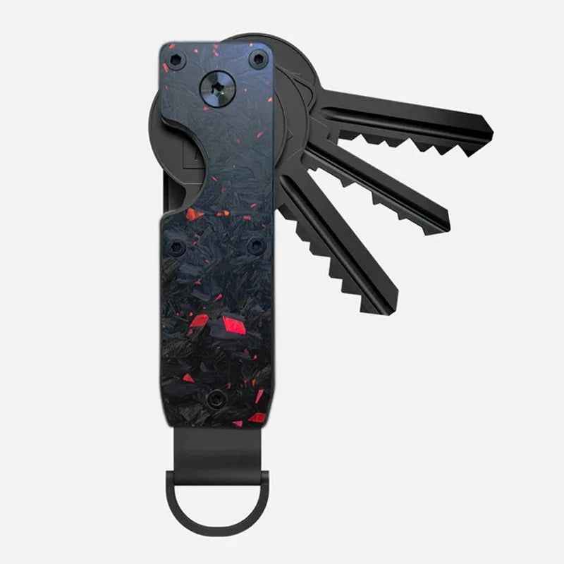 A black minimalist aluminum key organizer with a slot for keys and a set of keys attached.
