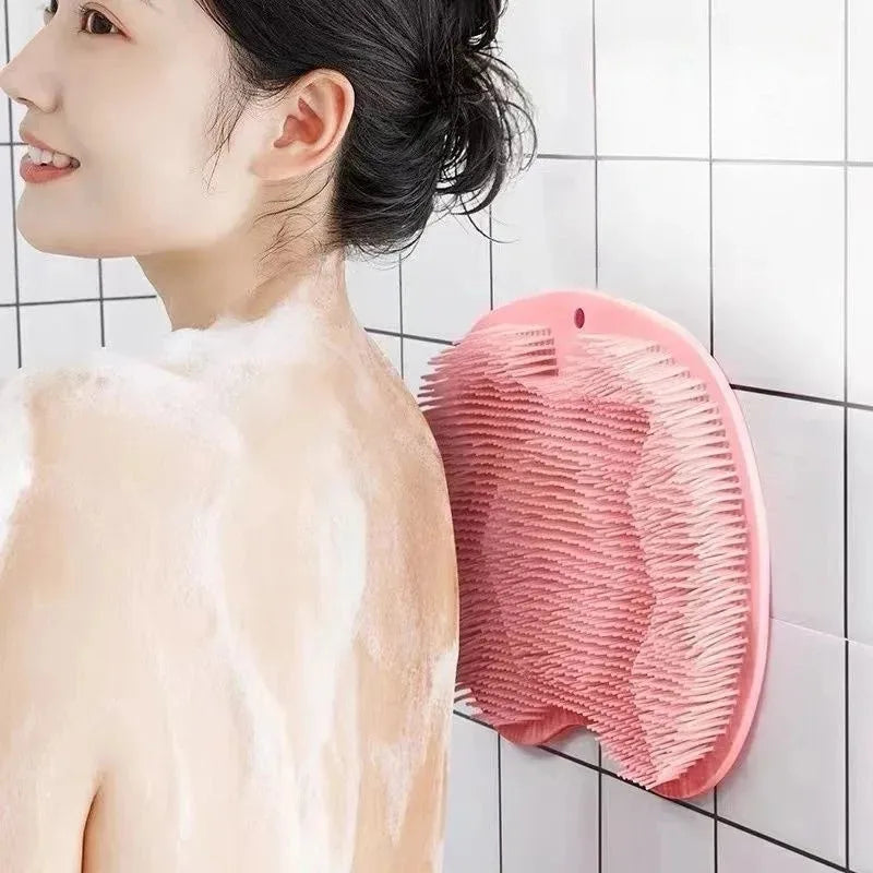 A pink suction cup foot massage mat with exfoliating bristles is shown against a white tiled background.