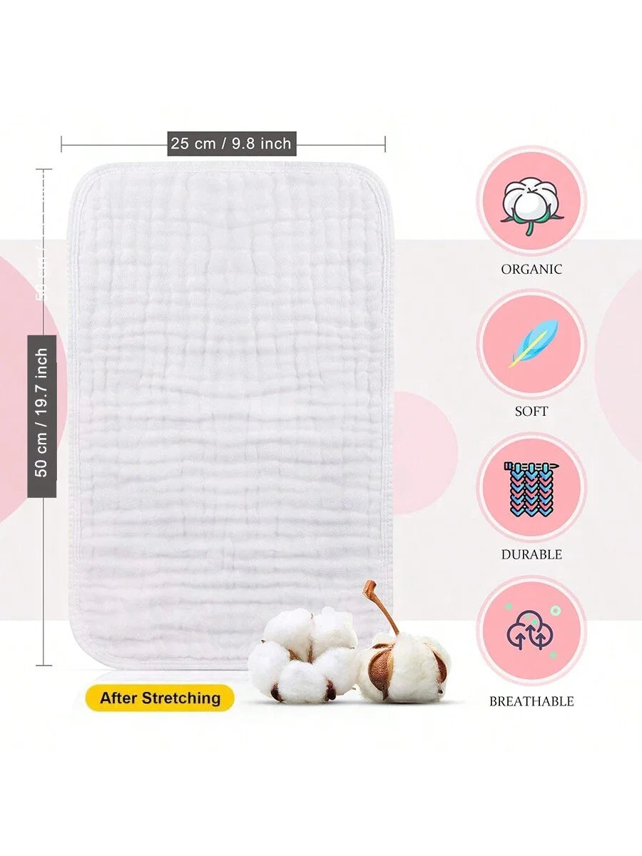 White organic muslin burp cloths shown flat and after stretching, with a fluffy cotton ball for scale.