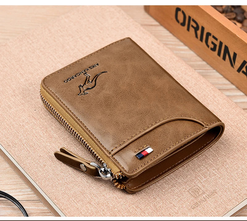 A brown leather wallet with a zipper and a logo is shown resting on a light wooden surface.