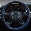A close-up view of a black car steering wheel with a blue crocodile grain leather cover.
