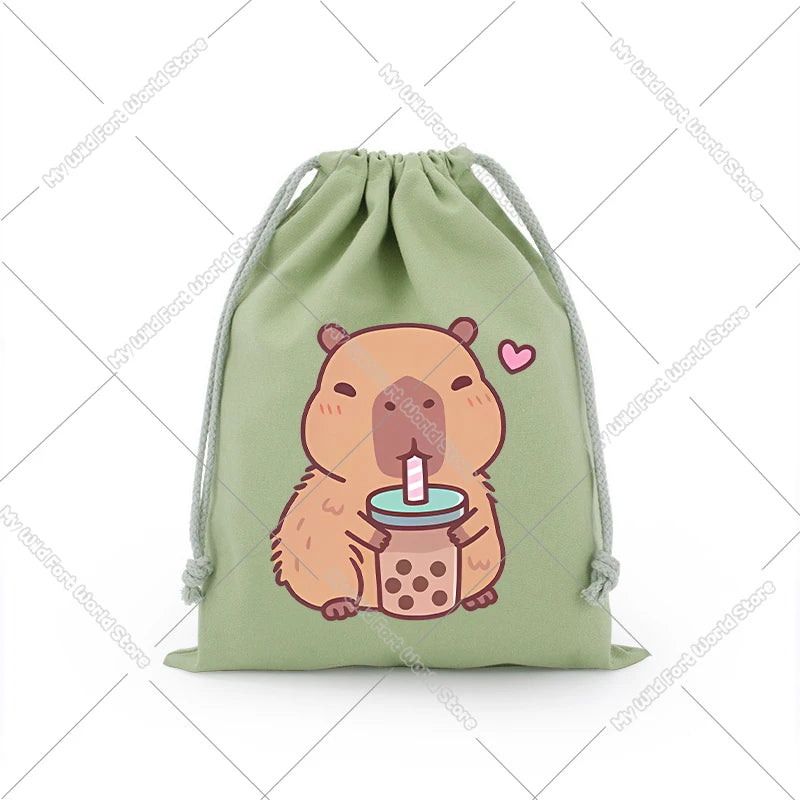 A light green drawstring storage bag featuring a cute, illustrated capybara holding a pink drink.