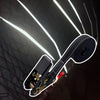 A close-up view of heavy duty ratchet tie down straps with a black strap and metal hardware against a dark background.