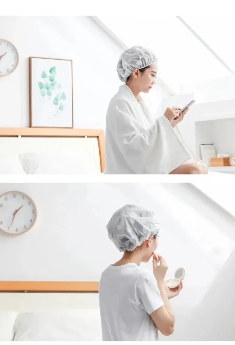 A woman wearing a white shower cap is looking at her phone in a bright bathroom setting.